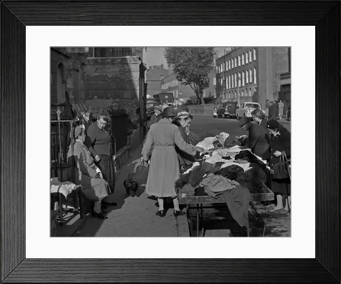 Framed Print : Sifting through old clothes at a market, London Framed Print : Sifting through old clothes at a market, London
