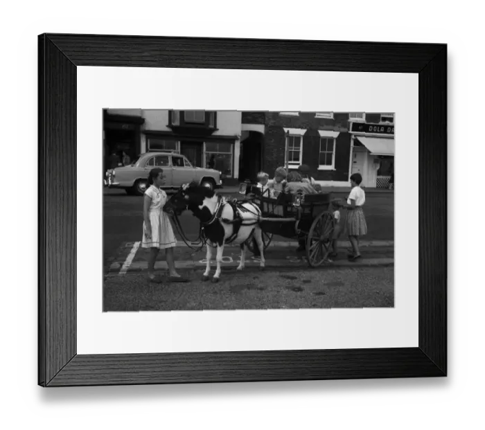 Framed Print : Pony giving a ride to children in his cart, Deal, Kent Framed Print : Pony giving a ride to children in his cart, Deal, Kent
