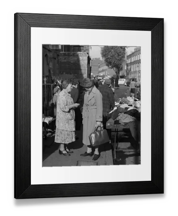 Framed Print : Two women chat at second hand clothes stall, London Framed Print : Two women chat at second hand clothes stall, London