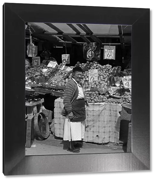 Woman and vegetable stall, East End of London