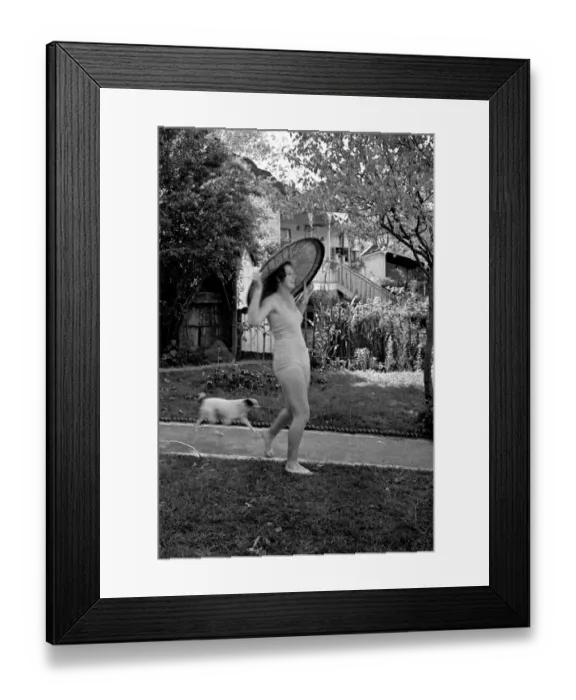Framed Print : Young woman and dog in a garden Framed Print : Young woman and dog in a garden
