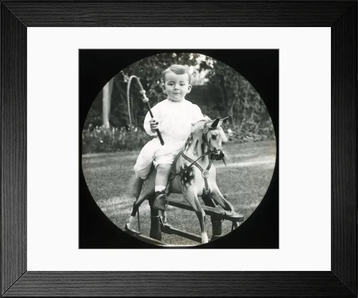 Framed Print : Little boy on a rocking horse with toy whip Framed Print : Little boy on a rocking horse with toy whip