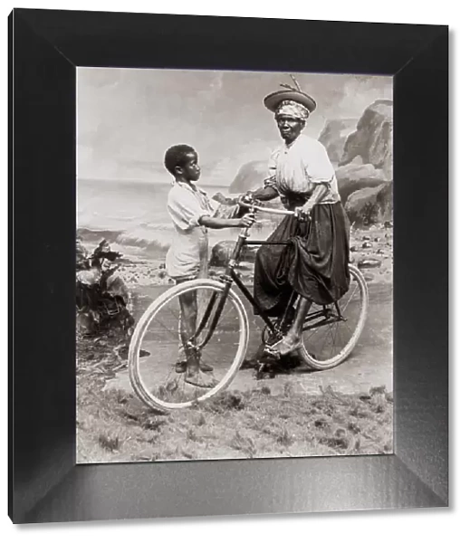 c. 1900 West Indies - old woman on bicycle with a child
