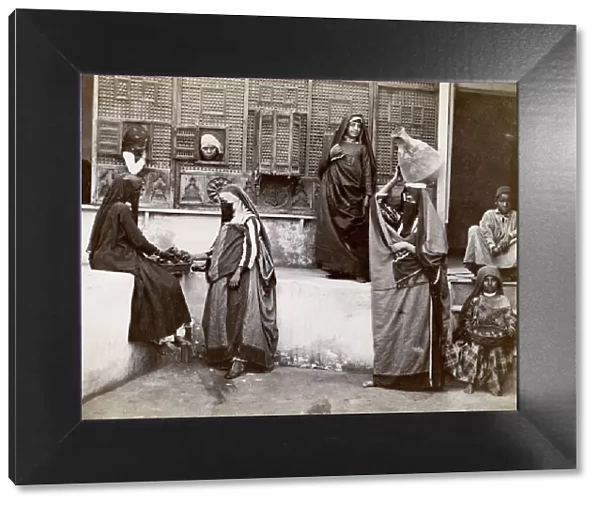 Egypt; interior of a courtyard, veiled women and children