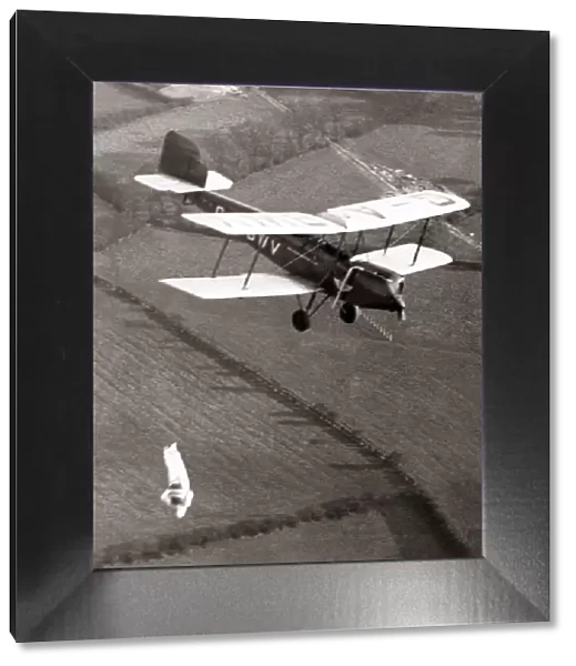 Parachuctisit jumps headfirst from biplane, Hayes, 1933