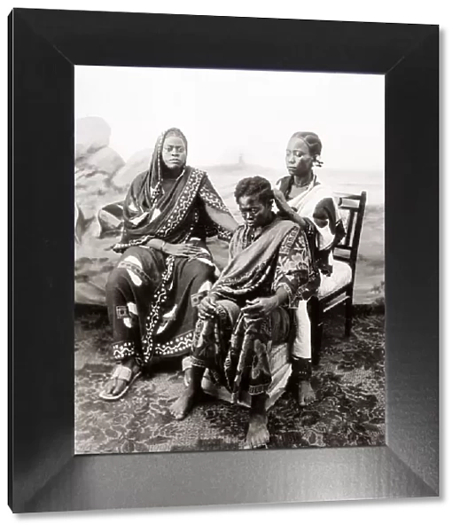 1900 Zanzibar - woman having her hair braided