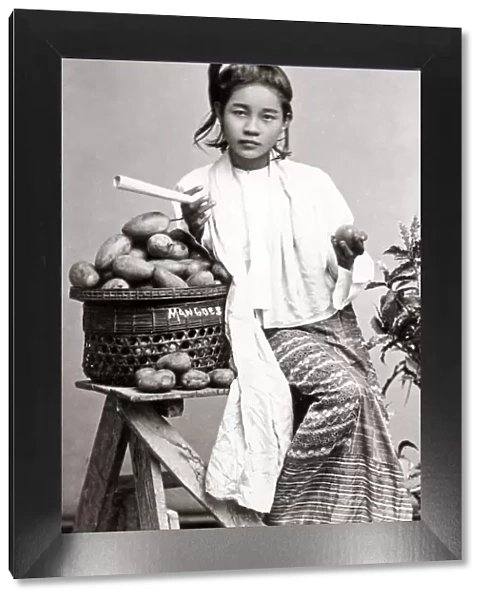 Young Burmese woman with mangoes, Burma
