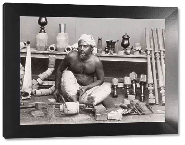 Wood turner working with a lathe, India