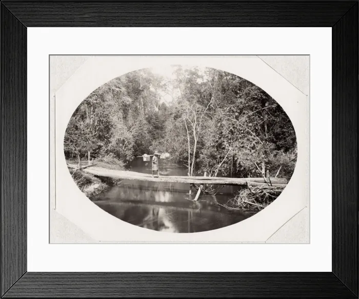 Framed Print : River scene, porter crossing a bridge, Madagascar Framed Print : River scene, porter crossing a bridge, Madagascar