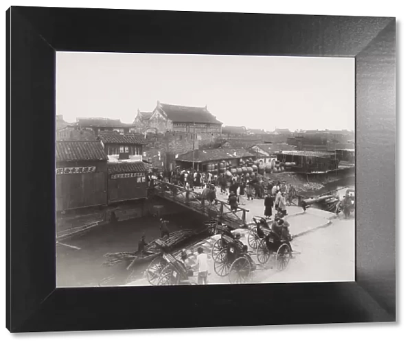 Late 19th century photograph: Bridge over river, busy with traffic, Shanghai, China
