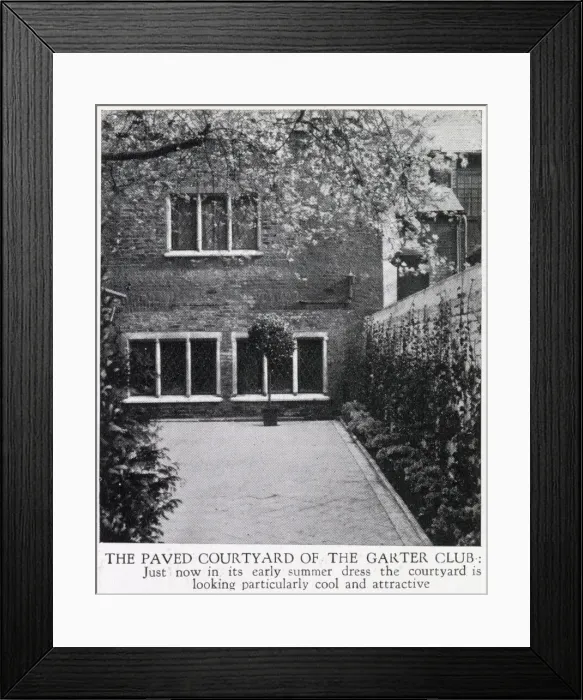 Framed Print : The Paved Courtyard of The Garter Club, the trees bedecked with early summer blossom Framed Print : The Paved Courtyard of The Garter Club, the trees bedecked with early summer blossom