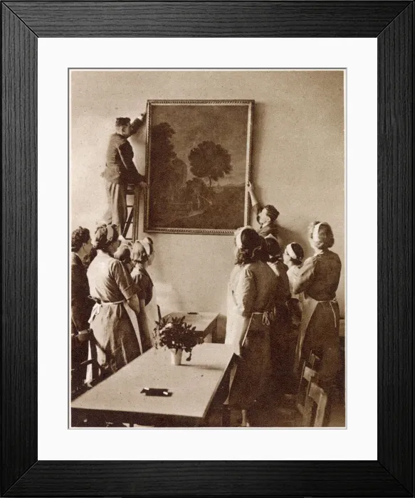 Framed Print : Hanging a painting of a romantic landscape in the new Churchill British Restaurant in Framed Print : Hanging a painting of a romantic landscape in the new Churchill British Restaurant in