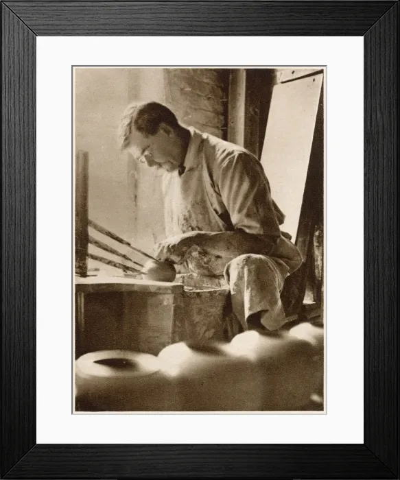 Framed Print : A man forming articles upon the potters wheel: a thrower. Date: 1913 Framed Print : A man forming articles upon the potters wheel: a thrower. Date: 1913