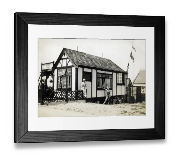 Framed Print : Two women in fashionable holiday outfits pose for their photograph outside their chalet Framed Print : Two women in fashionable holiday outfits pose for their photograph outside their chalet