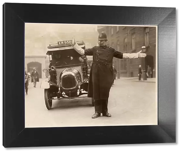 Traffic Policeman directing the traffic at Parliament Street, London. Date: circa 1930