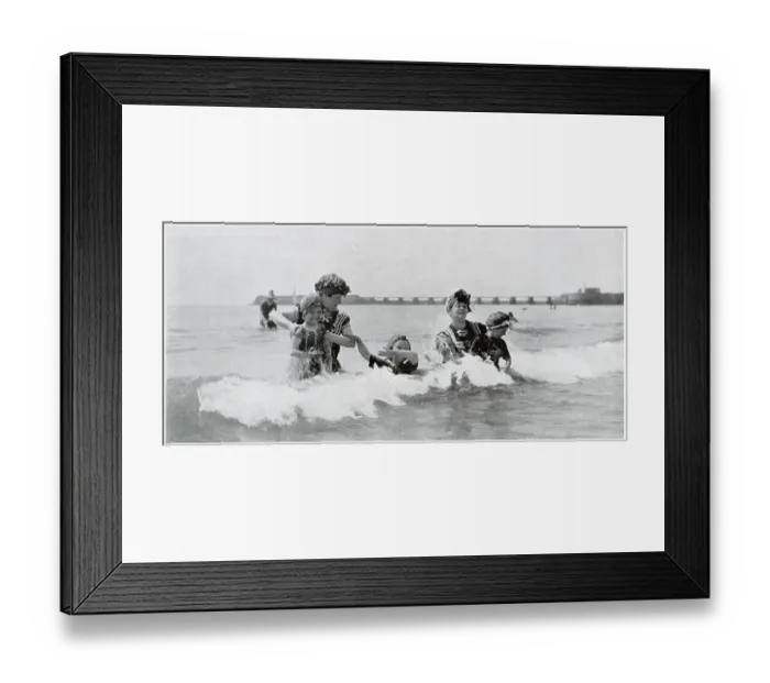 Framed Print : Two women taking their children for an early morning slash in the sea in Trouville. Date: August 1905 Framed Print : Two women taking their children for an early morning slash in the sea in Trouville. Date: August 1905