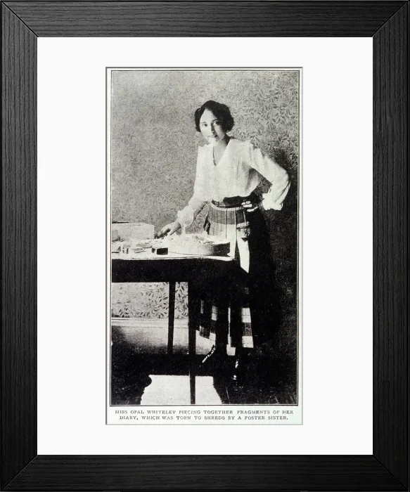 Framed Print : Opal Whiteley (1897 -1992), mysterious diarist, repairing her diary which was damaged by a foster sister Date: 1920 Framed Print : Opal Whiteley (1897 -1992), mysterious diarist, repairing her diary which was damaged by a foster sister Date: 1920