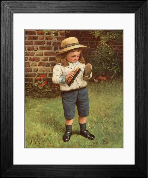 Framed Print : A young boy brushes his shoes. Date: 1910 Framed Print : A young boy brushes his shoes. Date: 1910