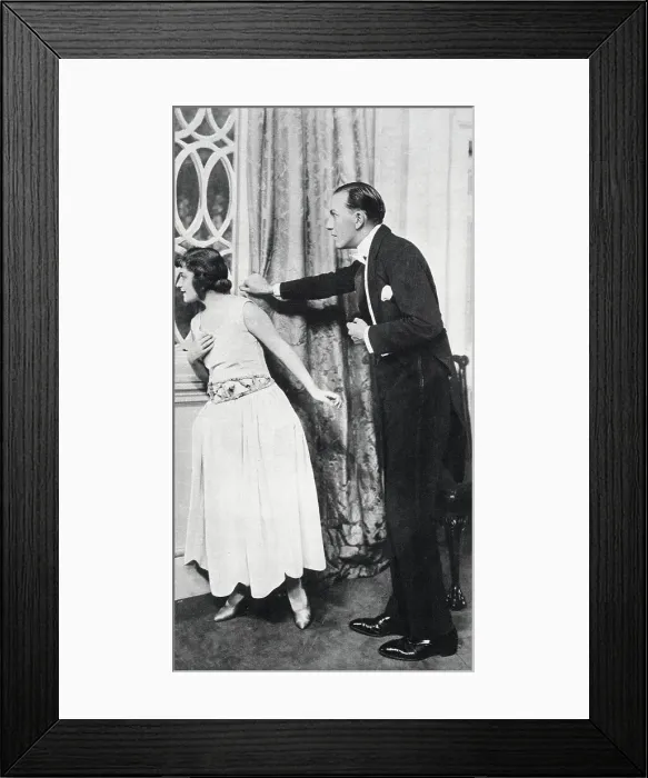 Framed Print : Noel Coward acts in his own play with Ann Trevor. Dressed for dinner, they peer anxiously out of a window. Date: 1923 Framed Print : Noel Coward acts in his own play with Ann Trevor. Dressed for dinner, they peer anxiously out of a window. Date: 1923