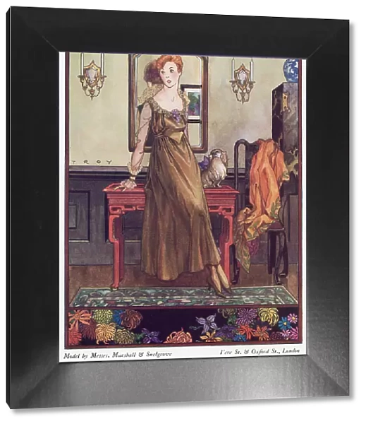 Marshall & Snelgrove gown: loose fitting, high waisted ankle length gown in a bronze fabric, round neckline, Medici style collar, translucent sleeves & reverse cuffs. Date: 1915