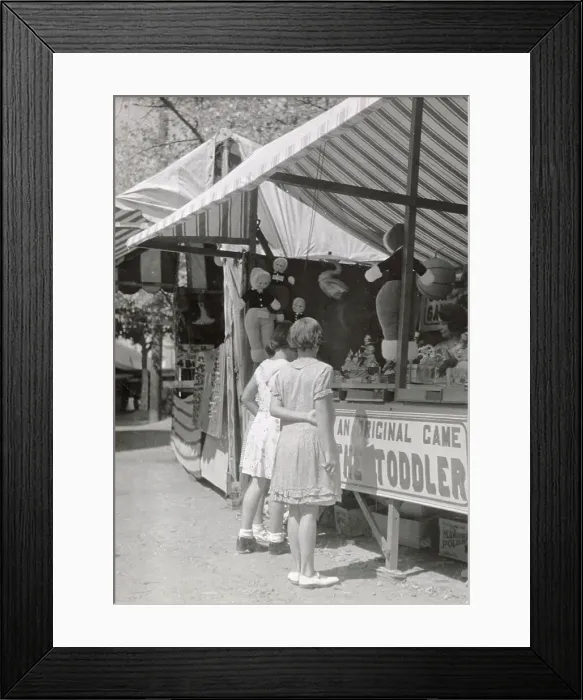 Framed Print : Girls looking at a stall at Looe fair, Cornwall Date: 1930s Framed Print : Girls looking at a stall at Looe fair, Cornwall Date: 1930s