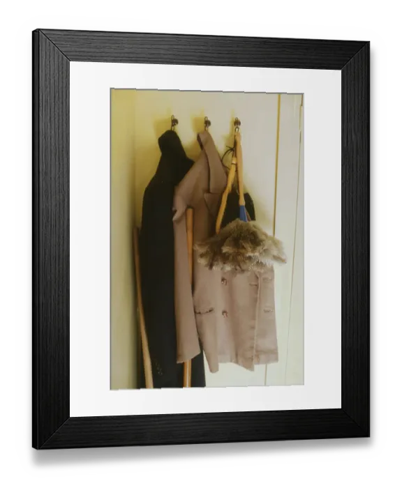 Framed Print : Two overcoats and a feather duster, hanging from three hooks behind a bedroom door. Date: 1940s (re-enactment) Framed Print : Two overcoats and a feather duster, hanging from three hooks behind a bedroom door. Date: 1940s (re-enactment)