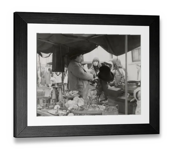 Framed Print : An stall holder chats up two young women at Portobello Road antiques market, London. Date: late 1960s Framed Print : An stall holder chats up two young women at Portobello Road antiques market, London. Date: late 1960s