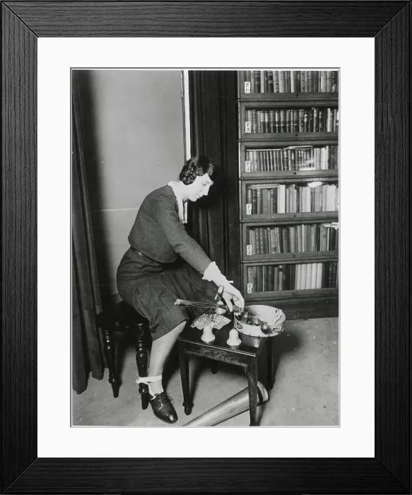 Framed Print : Harry Price's secretary, who assisted him in many of his investigations : here she is depicted with apparatus employed by fraudulent mediums. Date: early 20th century Framed Print : Harry Price's secretary, who assisted him in many of his investigations : here she is depicted with apparatus employed by fraudulent mediums. Date: early 20th century