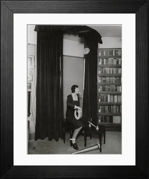 Framed Print : Ethel Beenham, Harry Price's secretary, demonstrates how a skilful medium can perform any number of psychic phenomena even though her hands and feet are tied. Date: 1930s ? Framed Print : Ethel Beenham, Harry Price's secretary, demonstrates how a skilful medium can perform any number of psychic phenomena even though her hands and feet are tied. Date: 1930s ?