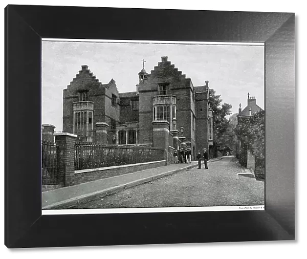 Exterior view of Harrow School, showing boys wearing their boaters. Date: 1896