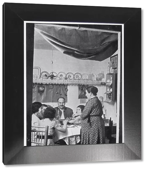 A Civil Guardsman having dinner with his family in their private rooms at a Civil Guard Barracks, Spain, 1936. The Civil Guard were a cross between a military unit and a police force