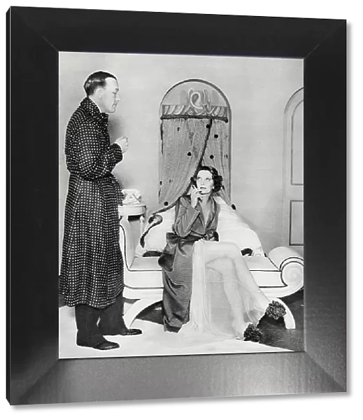 Photograph showing Noel Coward (1899-1973) and Gertrude Lawrence (1898-1952) starring in Coward's repertory Tonight at Seven Thirty, which included the piece Shadow Play, Manchester, 1935. Date: 1935