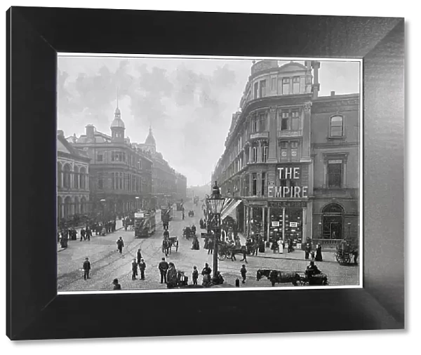 Photograph taken on the junction of Castle Place showing the Donegal Place with fine buildings throughout. Date: late 1890s