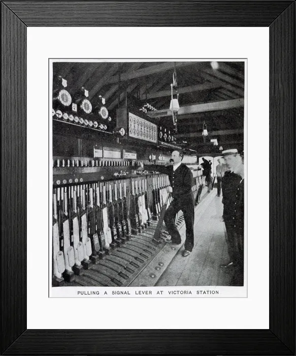 Framed Print : Photograph showing the signalman in the act of pulling a signal lever to allow a train to enter one of the platforms. Date: 1907 Framed Print : Photograph showing the signalman in the act of pulling a signal lever to allow a train to enter one of the platforms. Date: 1907