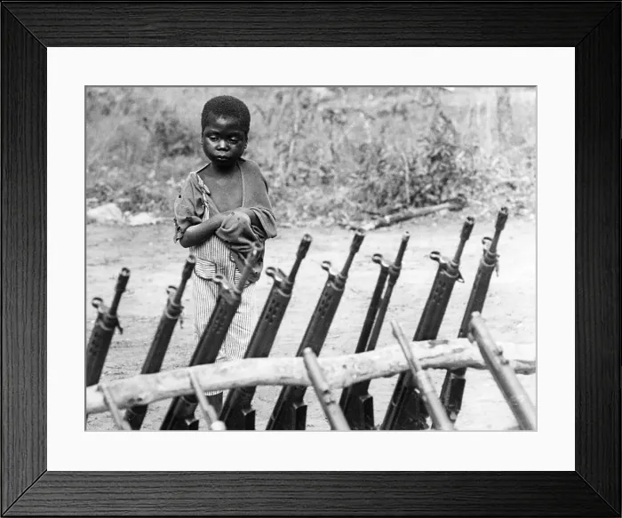 Framed Print : African orphan behind weapons Framed Print : African orphan behind weapons
