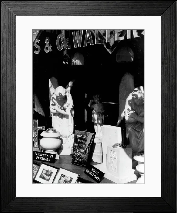Framed Print : Funerary monuments in display window Framed Print : Funerary monuments in display window