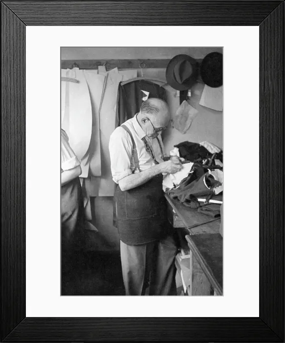 Framed Print : Tailor at work on a garment Framed Print : Tailor at work on a garment