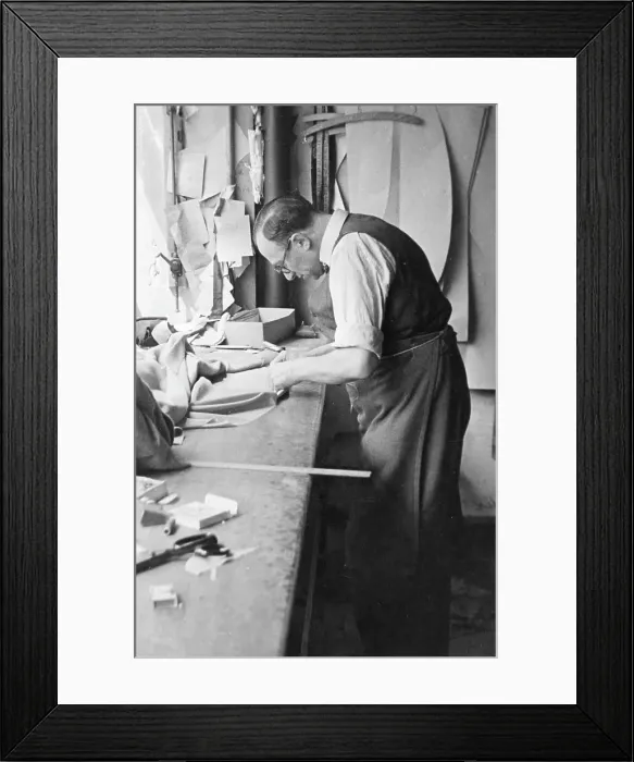 Framed Print : Tailor at work on a garment Framed Print : Tailor at work on a garment