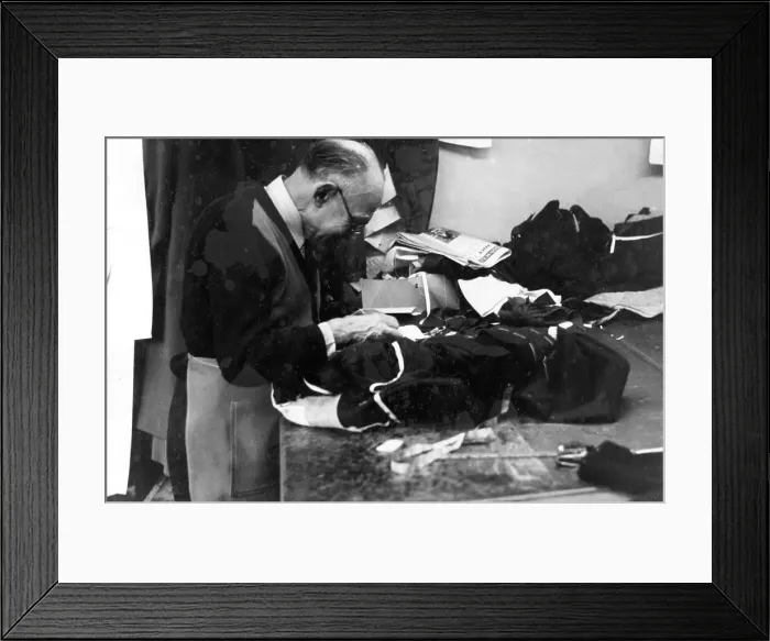 Framed Print : Tailor at work on a garment Framed Print : Tailor at work on a garment