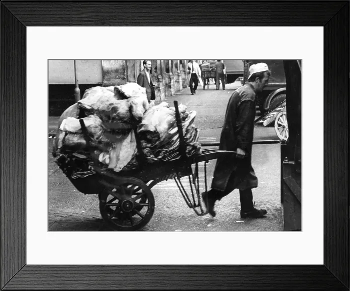Framed Print : Porter pulling a loaded cart at a market Framed Print : Porter pulling a loaded cart at a market