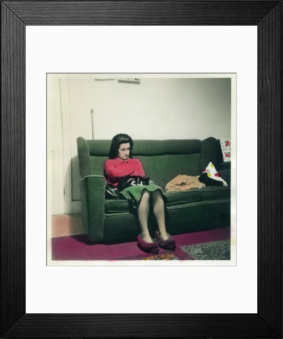 Framed Print : Woman in slippers seated on sofa Framed Print : Woman in slippers seated on sofa