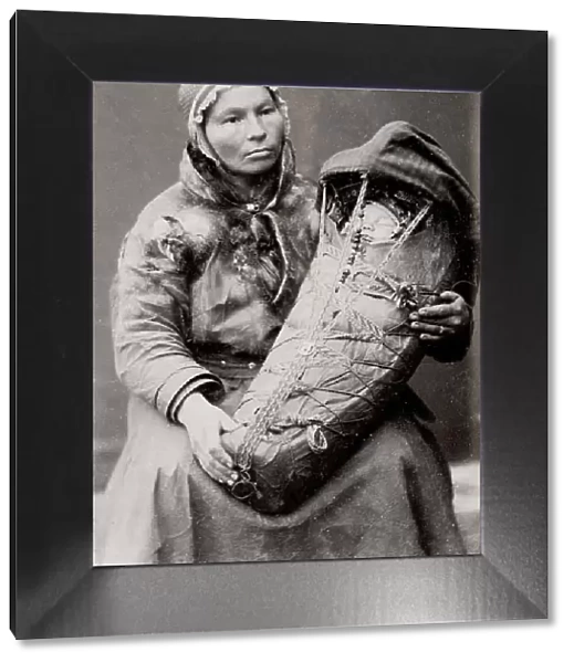 Sami woman with a baby in a papoose, Norway