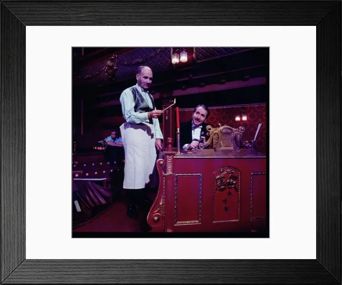 Framed Print : Two of the cast of the Old Time Music Hall TV show, known as The Good Old Days, filmed at the City Varieties in Leeds. The man on the left lights a candle, while the compere, played by the actor Leonard Sachs, smiles benignly. Date: 1960s Framed Print : Two of the cast of the Old Time Music Hall TV show, known as The Good Old Days, filmed at the City Varieties in Leeds. The man on the left lights a candle, while the compere, played by the actor Leonard Sachs, smiles benignly. Date: 1960s