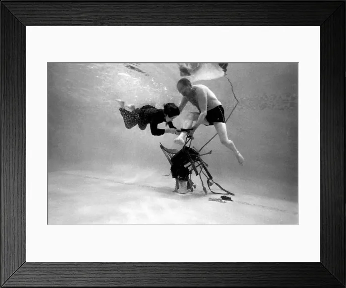 Framed Print : Underwater escapologist - a boy dives into a swimming pool to help a man untie himself from a chair. (2 of 3) Date: 1967 Framed Print : Underwater escapologist - a boy dives into a swimming pool to help a man untie himself from a chair. (2 of 3) Date: 1967