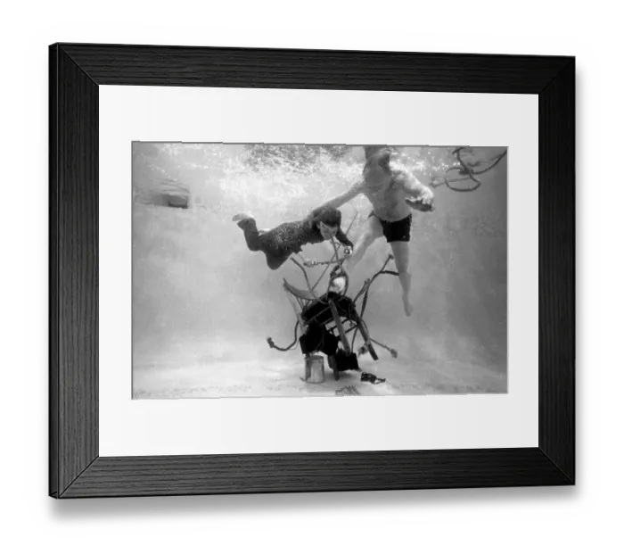 Framed Print : Underwater escapologist - a boy dives into a swimming pool to help a man untie himself from a chair. (3 of 3) Date: 1967 Framed Print : Underwater escapologist - a boy dives into a swimming pool to help a man untie himself from a chair. (3 of 3) Date: 1967