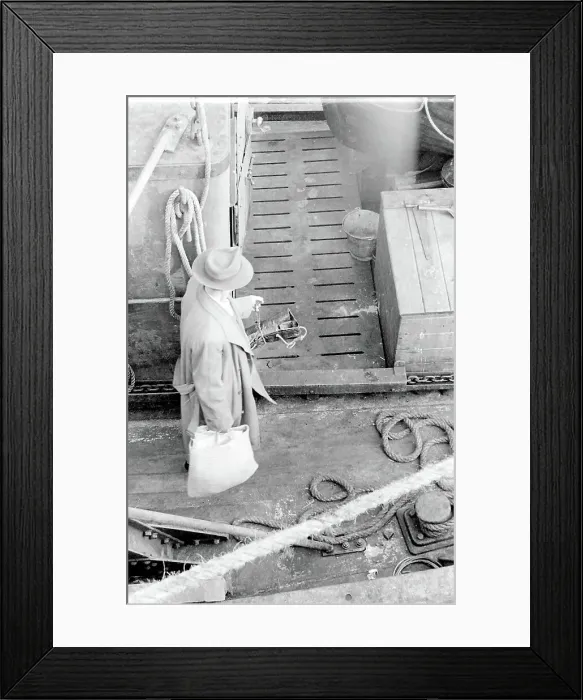 Framed Print : Life on a North Sea trawler - aerial view onto the deck - man in raincoat and trilby hat, carrying a shopping bag. Date: 1960s Framed Print : Life on a North Sea trawler - aerial view onto the deck - man in raincoat and trilby hat, carrying a shopping bag. Date: 1960s