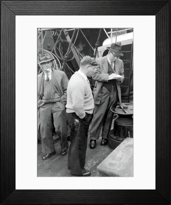 Framed Print : Life on a North Sea trawler - three men on deck in ordinary clothes, one of them writing on a piece of paper. Date: 1960s Framed Print : Life on a North Sea trawler - three men on deck in ordinary clothes, one of them writing on a piece of paper. Date: 1960s