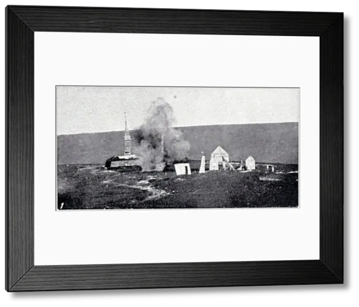 Framed Print : A dummy village made of canvas used for Artillery practise with Lyddite shells - near Okehampton, Dartmoor. A shell explodes near the Church'. Date: 1912 Framed Print : A dummy village made of canvas used for Artillery practise with Lyddite shells - near Okehampton, Dartmoor. A shell explodes near the Church'. Date: 1912