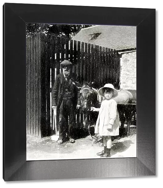Little girl and grandfather with donkey