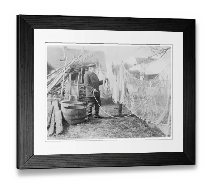 Framed Print : A German fisherman mending his nets Framed Print : A German fisherman mending his nets